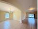 Bright open living space featuring tile floors, an arched doorway, and sliding glass doors to a lanai at 13181 Royal Pines Ave, Riverview, FL 33579