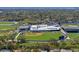 Drone's eye of well-equipped baseball field and building in green suburban neighborhood at 1393 Chesterfield Dr, Dunedin, FL 34698