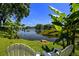 Backyard view of waterfront with chairs, bananas trees and blue skies at 1393 Chesterfield Dr, Dunedin, FL 34698