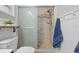 Beautiful bathroom featuring a walk-in shower, tile flooring, and white wainscoting at 1393 Chesterfield Dr, Dunedin, FL 34698