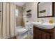 This bathroom features a vanity sink, a bathtub with shower, and a toilet at 1393 Chesterfield Dr, Dunedin, FL 34698