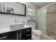 Renovated bathroom boasts modern vanity, and a glass-enclosed shower at 1393 Chesterfield Dr, Dunedin, FL 34698