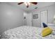 Relaxing bedroom with white walls features ceiling fan, closet, and comfortable bed and warm natural light at 1393 Chesterfield Dr, Dunedin, FL 34698