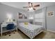 Cozy bedroom features a ceiling fan, a comfortable bed and desk, and warm, natural lighting at 1393 Chesterfield Dr, Dunedin, FL 34698