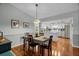Dining area and a modern kitchen, stainless steel appliances, and white cabinets at 1393 Chesterfield Dr, Dunedin, FL 34698