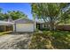 Well-maintained single-Gathering home with a charming front yard and attached garage at 1393 Chesterfield Dr, Dunedin, FL 34698