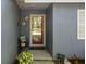 Charming front porch with decorative door and plants at 1393 Chesterfield Dr, Dunedin, FL 34698