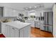 Bright kitchen features white cabinetry, stainless steel appliances, and center island at 1393 Chesterfield Dr, Dunedin, FL 34698