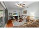 Cozy living room featuring hardwood floors, a ceiling fan, and a sliding glass door at 1393 Chesterfield Dr, Dunedin, FL 34698