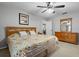 Bedroom features neutral colors, a ceiling fan, and a double dresser at 1393 Chesterfield Dr, Dunedin, FL 34698