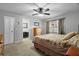 Bedroom features neutral colors, a ceiling fan, and an ensuite bathroom at 1393 Chesterfield Dr, Dunedin, FL 34698