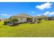 Expansive backyard featuring a lovely stone patio and lush green lawn, great for entertaining at 13953 Thoroughbred Dr, Dade City, FL 33525