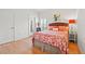 Bright bedroom featuring hardwood floors, and tropical decor at 13953 Thoroughbred Dr, Dade City, FL 33525