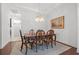 Formal dining room with hardwood floors, chandelier, and a decorative area rug at 13953 Thoroughbred Dr, Dade City, FL 33525