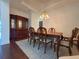 Elegant dining room with wood table, chairs, and beautiful chandelier at 13953 Thoroughbred Dr, Dade City, FL 33525