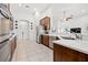 Open-concept kitchen with tile flooring, white countertops, and stainless steel appliances at 13953 Thoroughbred Dr, Dade City, FL 33525