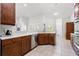 Open kitchen with stainless steel appliances and beautiful stone countertops at 13953 Thoroughbred Dr, Dade City, FL 33525