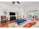 Cozy living room with hardwood floors, neutral decor, and a seamless connection to the outdoor patio at 13953 Thoroughbred Dr, Dade City, FL 33525