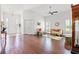 Open-concept living room with high ceilings, hardwood floors, and a seamless flow into the foyer at 13953 Thoroughbred Dr, Dade City, FL 33525