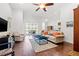 Spacious living room featuring hardwood floors, plantation shutters, and a sliding glass door to the patio at 13953 Thoroughbred Dr, Dade City, FL 33525