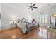 Spacious main bedroom with wood floors, tray ceiling, and large windows at 13953 Thoroughbred Dr, Dade City, FL 33525