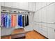 Well-organized walk-in closet with ample shelving, cabinets and hardwood floors at 13953 Thoroughbred Dr, Dade City, FL 33525