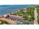 Aerial view of complex with parking and nearby waterfront with lush greenery at 1420 Bayshore Blvd # 409, Dunedin, FL 34698