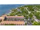 Aerial view of a multi-story condo with terracotta tiled roof and waterfront access at 1420 Bayshore Blvd # 409, Dunedin, FL 34698