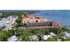 Aerial view of residential neighborhood and condo building with terracotta tile roofs near the water at 1420 Bayshore Blvd # 409, Dunedin, FL 34698