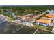 Aerial view of waterfront condos with multiple pools, lounge area, and pier access at 1420 Bayshore Blvd # 409, Dunedin, FL 34698