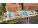 A bird's-eye view of a condo complex featuring two swimming pools and ample seating at 1420 Bayshore Blvd # 409, Dunedin, FL 34698