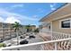 Exterior balcony view of condo building, palm trees and parking, creating an inviting outdoor living space at 1420 Bayshore Blvd # 409, Dunedin, FL 34698