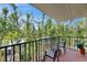 Relaxing balcony with seating overlooking a lush garden with mature trees at 1420 Bayshore Blvd # 409, Dunedin, FL 34698