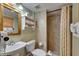 Bathroom featuring tiled shower, ample shelving, and a mirror above the sink creating a functional and comfortable space at 1420 Bayshore Blvd # 409, Dunedin, FL 34698