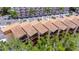 Close-up of a condo building with balconies and terracotta roofs nestled among trees at 1420 Bayshore Blvd # 409, Dunedin, FL 34698