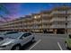 Condo building with multiple levels of units, each having balconies and ground-level parking with secure access at 1420 Bayshore Blvd # 409, Dunedin, FL 34698