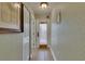 Hallway displaying a decorative picture, a view of the front door, and tile flooring at 1420 Bayshore Blvd # 409, Dunedin, FL 34698