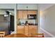 Studio kitchenette with wood cabinetry, countertop, microwave, and essential appliances at 1420 Bayshore Blvd # 409, Dunedin, FL 34698
