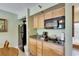 Cozy kitchenette area boasts wood cabinetry and counter space with essential appliances at 1420 Bayshore Blvd # 409, Dunedin, FL 34698
