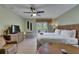 Comfortable living space featuring a king bed, TV, wicker dresser, and French doors at 1420 Bayshore Blvd # 409, Dunedin, FL 34698