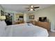 Open-concept living area featuring a king bed, kitchenette, dining area, and TV at 1420 Bayshore Blvd # 409, Dunedin, FL 34698