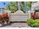 A monument sign for Beso Del Sol Resort with manicured landscaping and the Marker Tiki Bar event information at 1420 Bayshore Blvd # 409, Dunedin, FL 34698