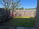 Back yard features a wooden fence for privacy at 1512 Chateaux De Ville Ct, Clearwater, FL 33764