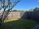 Fenced backyard with green grass and a tree in view at 1512 Chateaux De Ville Ct, Clearwater, FL 33764