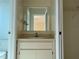 Compact bathroom showcasing a vanity with white cabinetry and ample storage space at 1512 Chateaux De Ville Ct, Clearwater, FL 33764