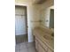 Bathroom featuring a vanity with a sink, mirror, and a doorway to a walk-in closet at 1512 Chateaux De Ville Ct, Clearwater, FL 33764