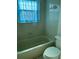This bathroom features a bathtub with tile surround and a modern toilet at 1512 Chateaux De Ville Ct, Clearwater, FL 33764