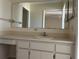 Bathroom featuring a built-in vanity with sink and mirror at 1512 Chateaux De Ville Ct, Clearwater, FL 33764