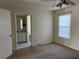 Bedroom with carpet, a ceiling fan, and a view into the en-suite bathroom at 1512 Chateaux De Ville Ct, Clearwater, FL 33764
