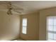 A cozy bedroom features a ceiling fan and bright natural light at 1512 Chateaux De Ville Ct, Clearwater, FL 33764